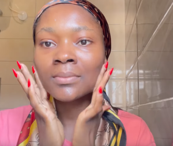 Woman applying A-Ret gel retinol serum in the washroom at night