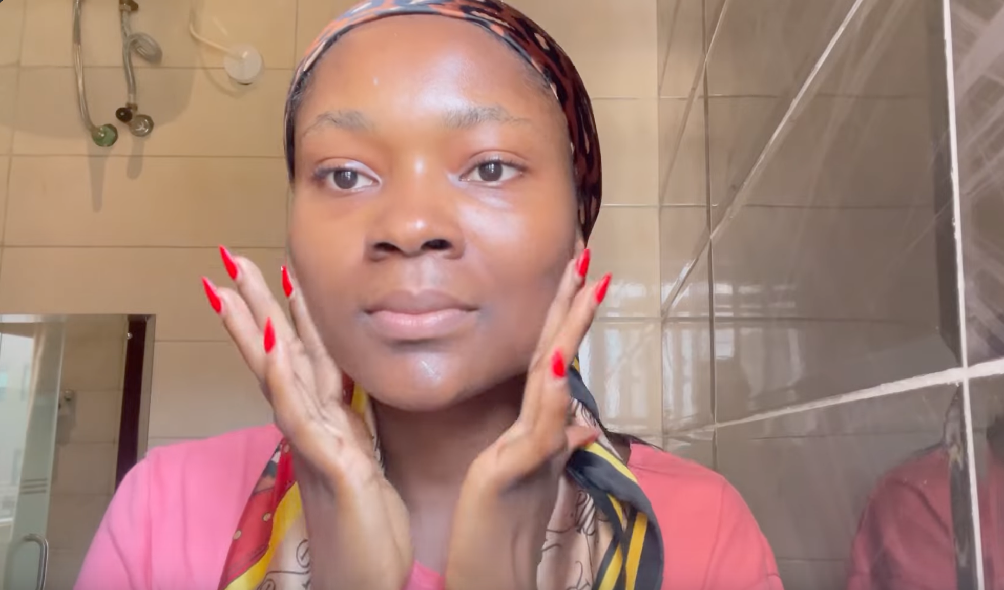 Woman applying A-Ret gel retinol serum in the washroom at night